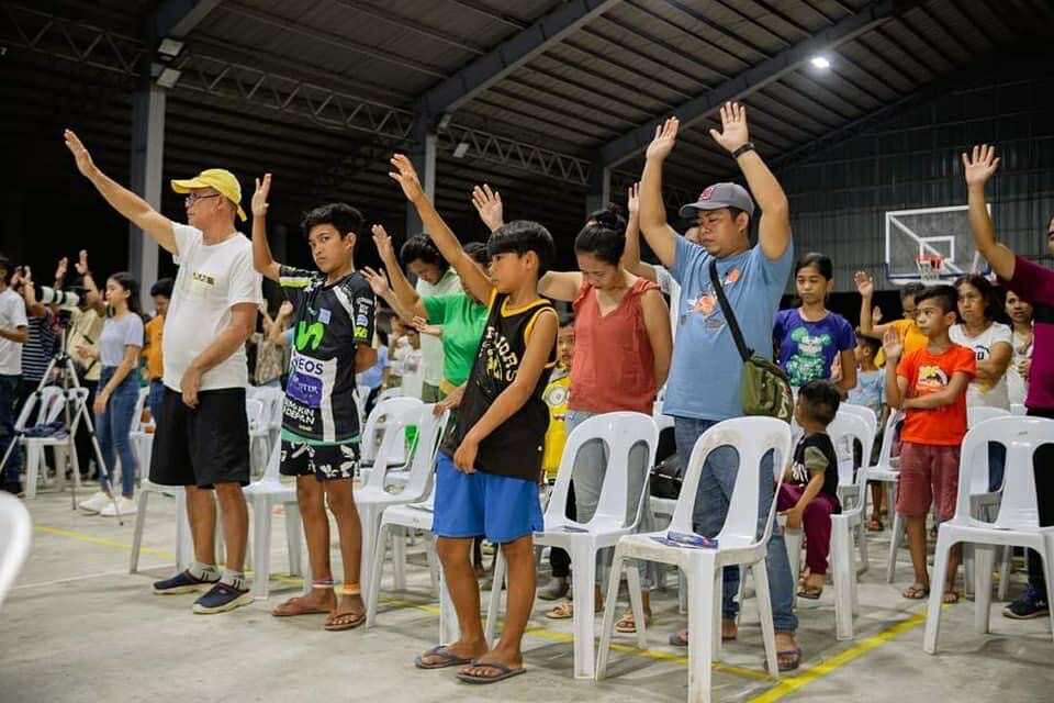 Families and children worshipping together