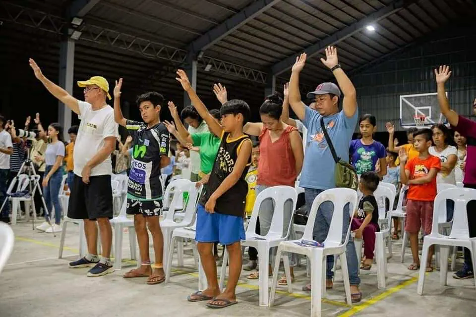 Families and children worshipping together