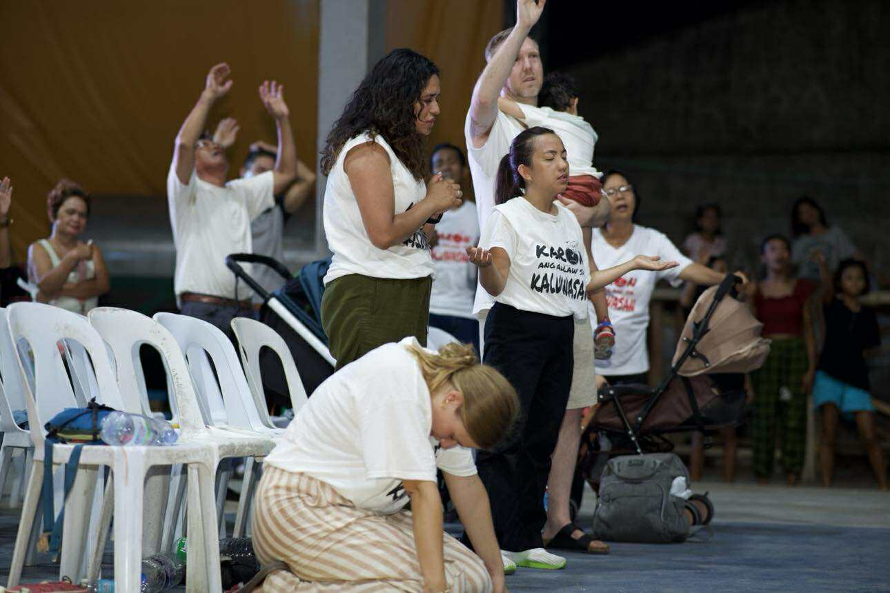 Volunteers and locals worshipping together