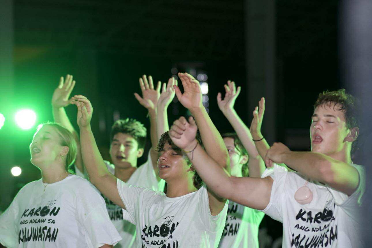 Youth worshipping on stage