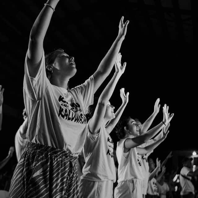 Worshippers lifting hands in prayer